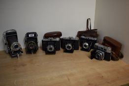 Six folding cameras. A Retina 1B, an Adox, a Franka Werks, two Zeiss Ikon and a Pontiac