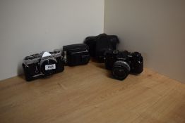 Two Olympus OM-1 camera bodies with an Olympus OM-System Zuiko MC Auto S 1:1,8 50mm lens and an