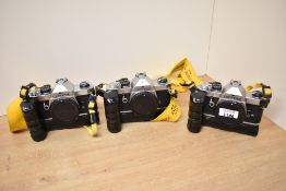 Three Pentax MX camera bodies on winders