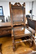 A 19th Century oak hall chair having solid seat and back, on turned frame