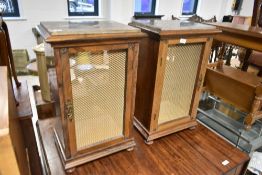 A pair of vintage speaker cabinets having marble tops