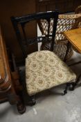 A Victorian ebonised bedroom chair in the Aesthetic style