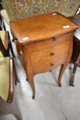 A period style bedside or work table, having brushing slide and two drawers to front and drawer to