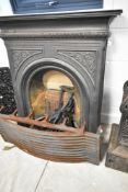 A Victorian style cast iron fire surround, together with a Swans nest style fire grate and dogs