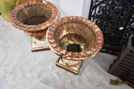 A pair of small campagna style cast garden urns, height approx. 39cm