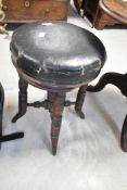 A Victorian piano stool having turned frame
