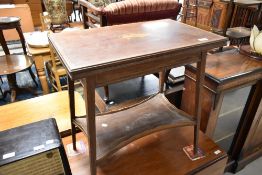 A 19th Century fold over occasional table with inlaid musical decoration and shaped galleried
