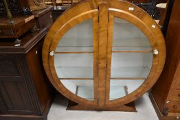 An Art Deco walnut display cabinet of circular form, width approx. 118cm