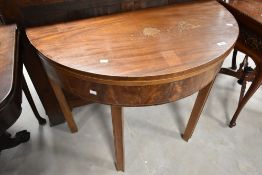 A 19th Century mahogany demi lune fold over tea or dining table, diameter approx. 100cm