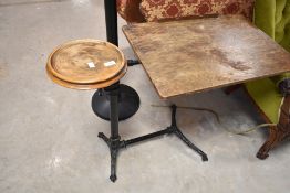A vintage industrial work table having cast frame , possibly sewing machine or factory