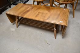 A vintage Ercol coffee table having drop ends and railed undertier, approx. 108 x 44cm