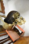 A 19th Century brass coal helmet, embossed with fruit and foliate decoration, sold with a