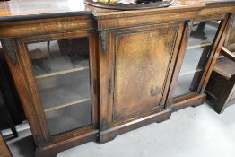 A 19th Century mahogany/kingswood Empire style breakfront display cabinet having central enclosed