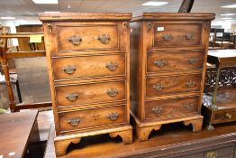 A pair of reproduction yew wood period style drawers with fold over desk top , with pull out