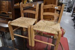 A pair of vintage rush seated child's chairs