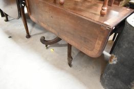 A 19th Century mahogany drop leaf dining table having drop flap on pedestal base with quadruple