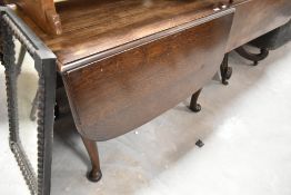 A late 19th or early 20th Century oak drop leaf dining table, approx closed size 97 x 67cm