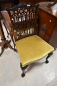 A late 19th or early 20th Century pagoda style fretwork dining chair having dralon upholstery