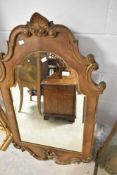 A reproduction ornate wall mirror, approx. 106 x 65cm