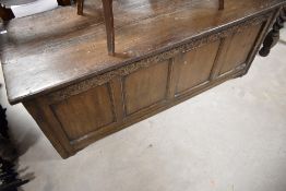 A period oak kist of having carved frieze and four plain panels, approx dimensions 143 x 52 x 56cm