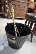 A vintage firebucket and brass hose fittings
