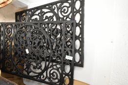 A pair of cast metal grilles or grates, each approx. 58 x 35cm