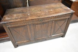 An 18th century oak three panel coffer, of hinged rectangular form, the moulded plank top opening to