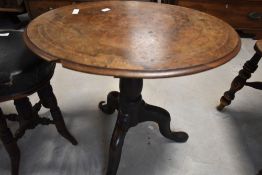 A 19th Century occasional table having walnut oval top on heavy oak turned base with triple legs,