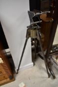 A vintage scratch built metal tripod stand, having adjustable legs and rotating top with angle