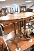 A Victorian oval occasional table having inlay to top and turned quadruple supports and splay