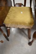 A 19th Century and later upholstered footstool having splay legs