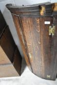 A 19th Century oak bow fronted corner cupboard