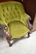 A Victorian button back armchair having knurl frame