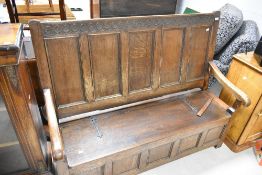 An early to mid 20th Century oak box settle, width approx. 140cm