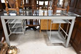 A modern glass topped office desk, approx. 150 x 70cm
