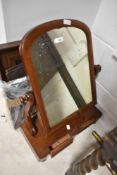 A Victorian mahogany toilet mirror and a later vintage wall mirror