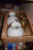 A pair of brass ceiling lights in the form of oil lamps.