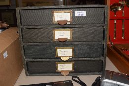 A set of vintage desk top filing drawers.
