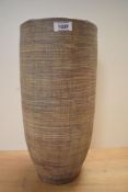 A contemporary terracotta cylinderical vase, sticker to base 'Made in Thailand' h39cm.