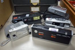 A selection of cameras. A Minolta Pocket Autopak 460TX, a Boots Pocket 110EF, a Pentax ESPIO 838G