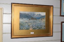 A print depicting a girl picking flowers in a bluebell meadow surrounded by mountains. Framed and