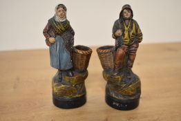 Two small vintage terracotta figures depicting both male and female fishermen, markings to front and