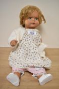 A vintage plaster doll having moveable limbs and head.