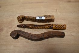 A group of three 19th century knitting sticks, of of scrolled form with notch carvings and named