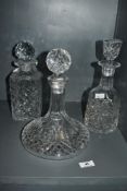 A group of three crystal decanters, to include a Stuart's crystal baluster style decanter, mark to