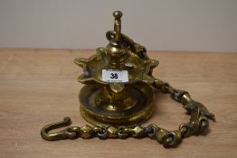 A heavy brass Middle Eastern style suspending oil lamp with chain, L63cm.