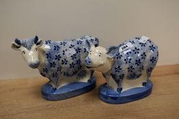 A pair of Mooreland Staffordshire pottery figures, hand coloured in a blue and white glaze, to