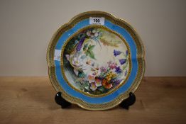 A fine hand painted English porcelain plate, decorated with flowers within a turquoise border,