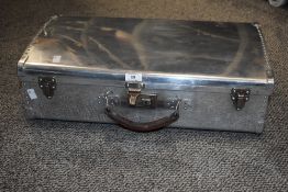 A 1930's aluminium flight case having hammer and rivat joints and leather handle, w56cm.