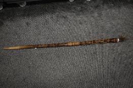 An early 20th century hand carved African tribal Tiki walking stick, decorated depicting elongated